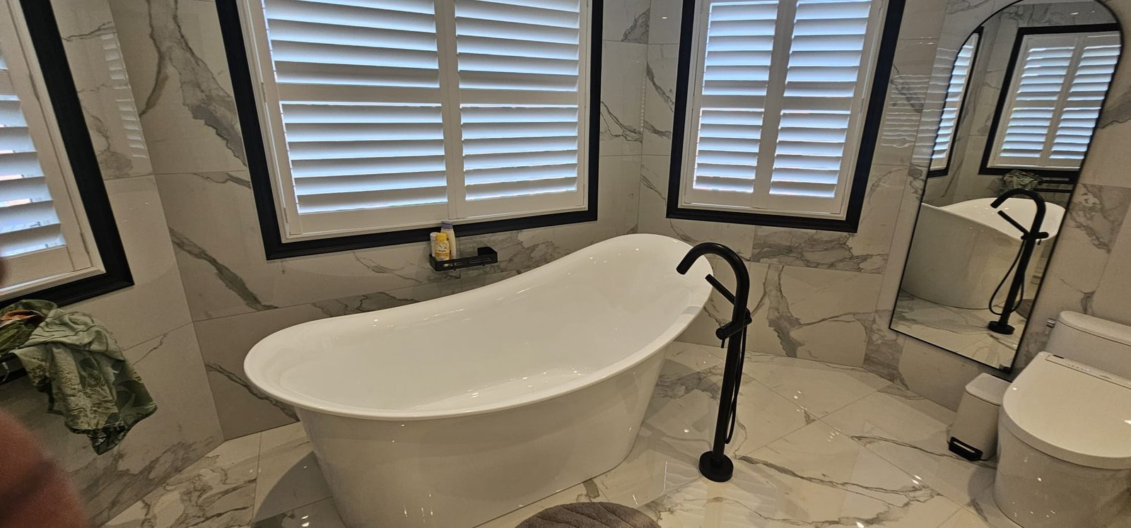 Elegant freestanding tub in marble bathroom - second angle