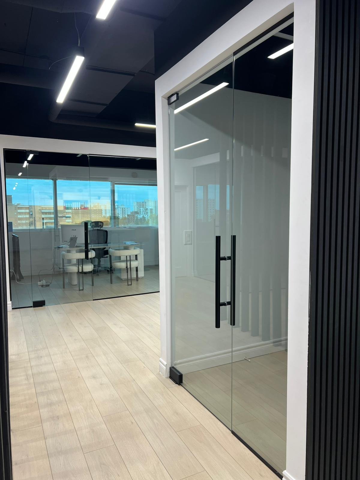 Commercial glass office partition installation - modern workspace