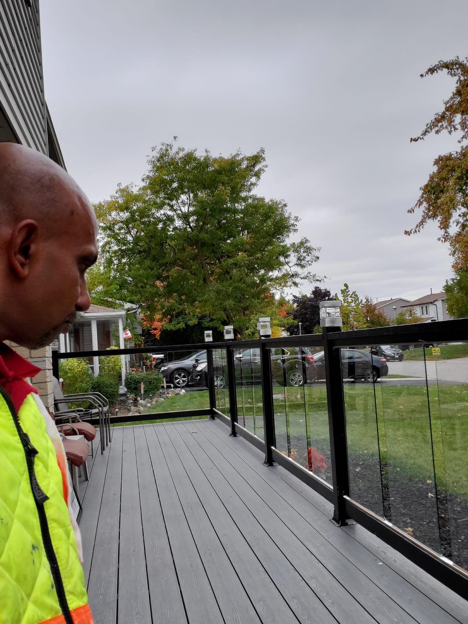 Glass panel railing on composite deck - modern outdoor renovation