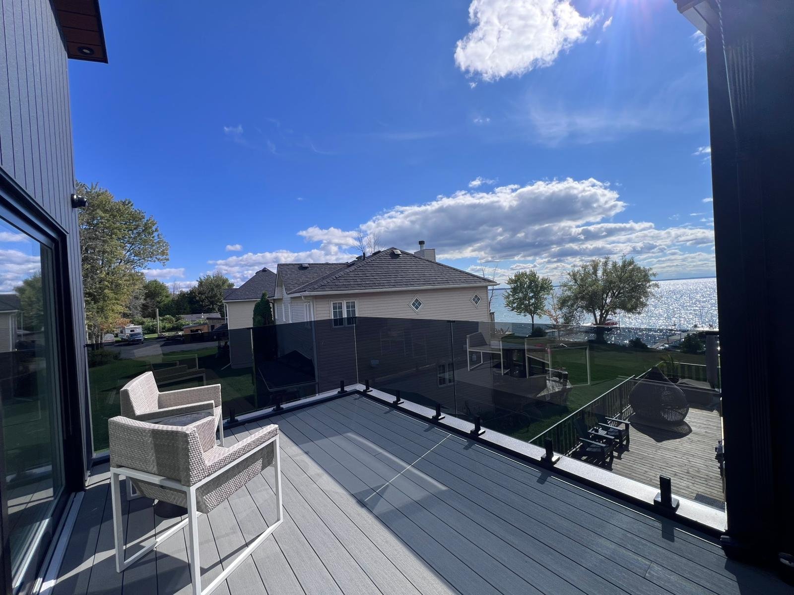 Composite deck with glass panel railing and stunning lake view