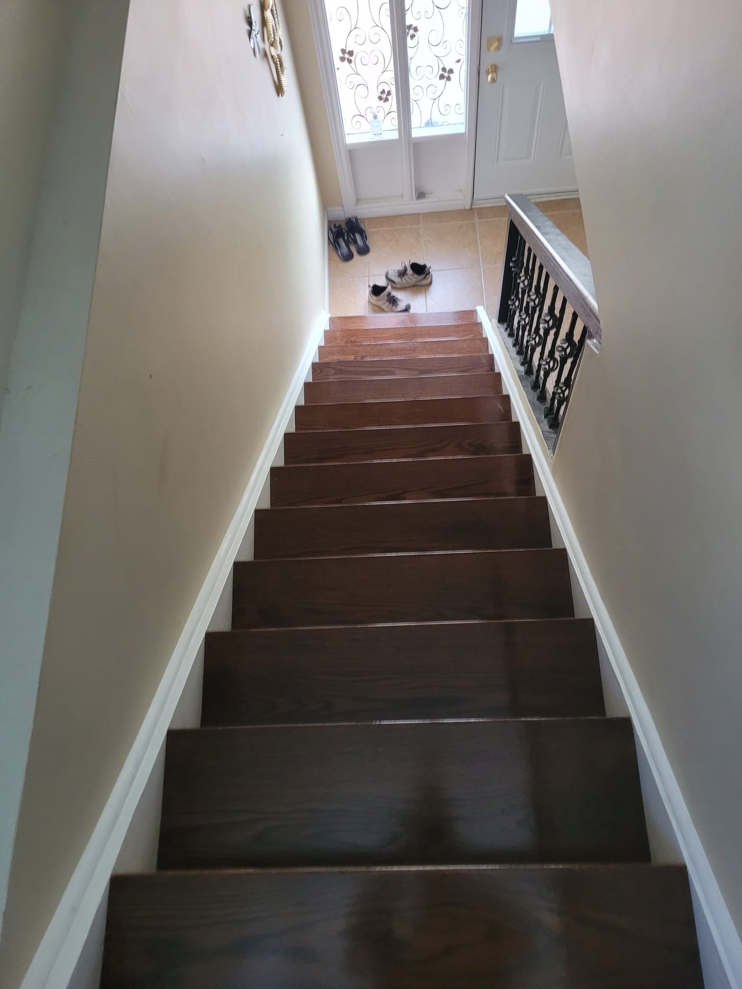 Dark hardwood staircase with iron balusters