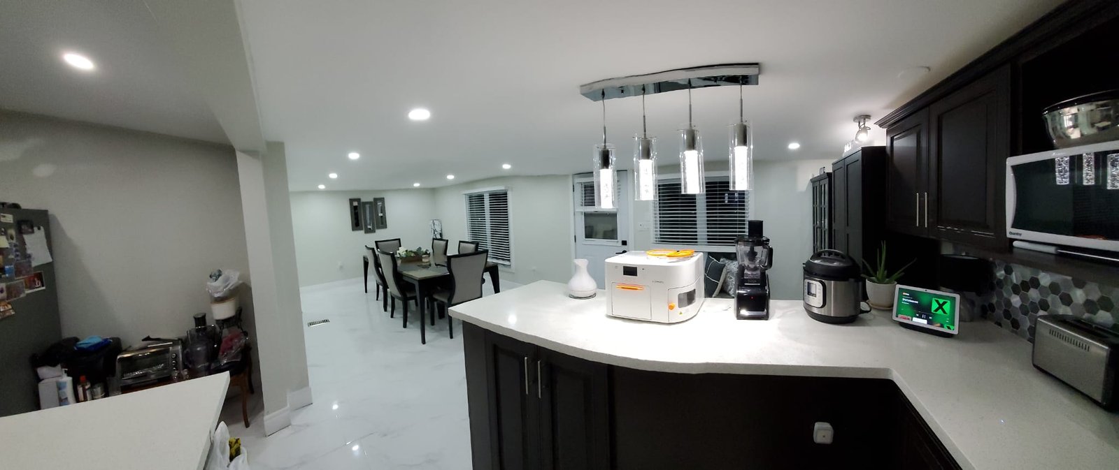 Stunning dark kitchen with island and designer pendant lighting
