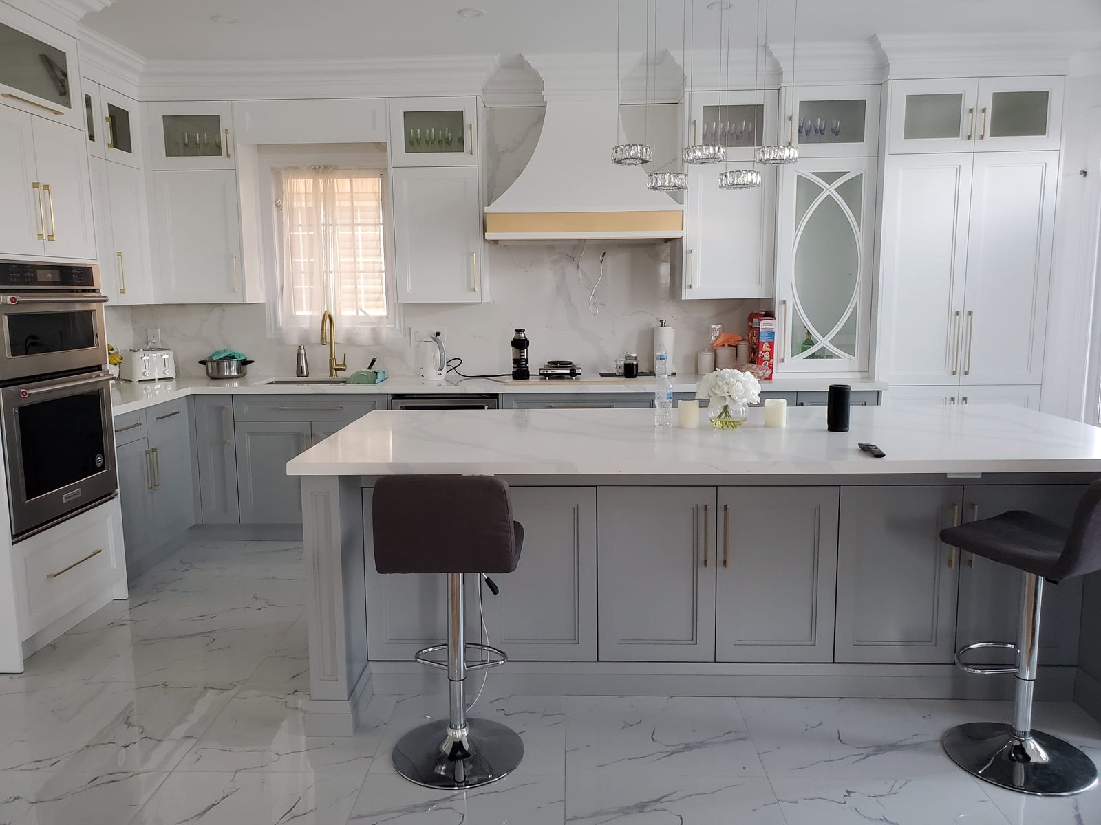 Gray and white kitchen renovation with island and pendant lights