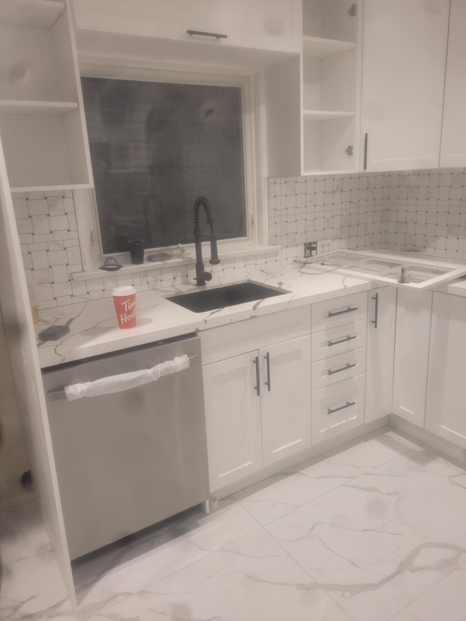 White kitchen cabinetry with black undermount sink